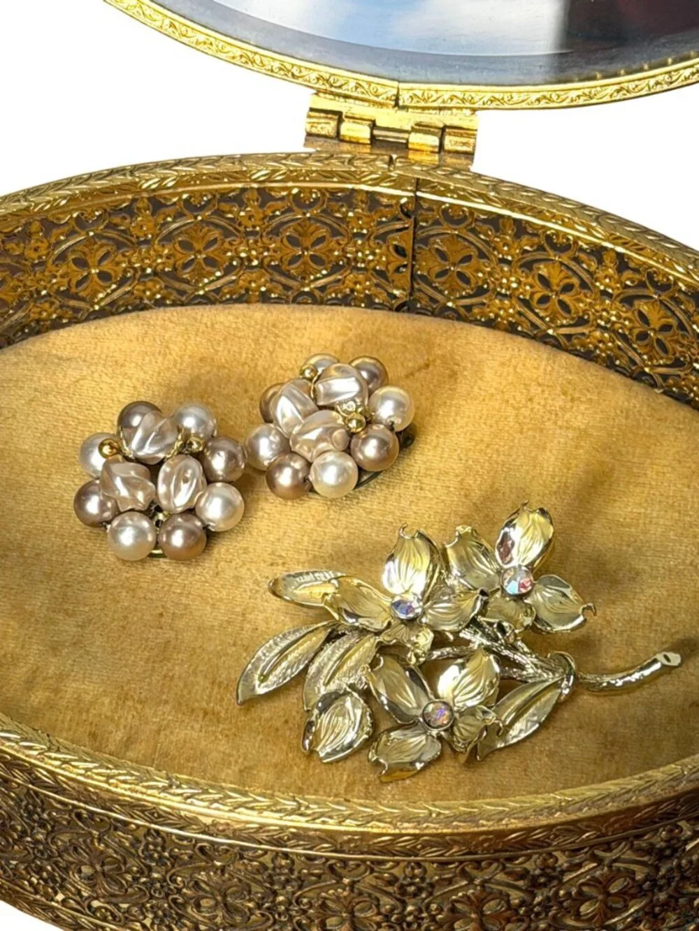 Vintage Hollywood Regency style brass filigree jewelry box with beveled glass to